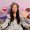 Pleasant looking woman with long dark hair, keeps lips rounded, prepares for hen party, gets beauty treatments at home, wears comfortable grey bathrobe, feels relaxed and refreshed after taking bath